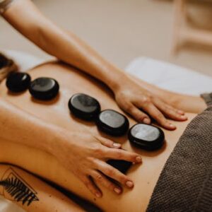 A soothing hot stone massage therapy session for relaxation and wellness.